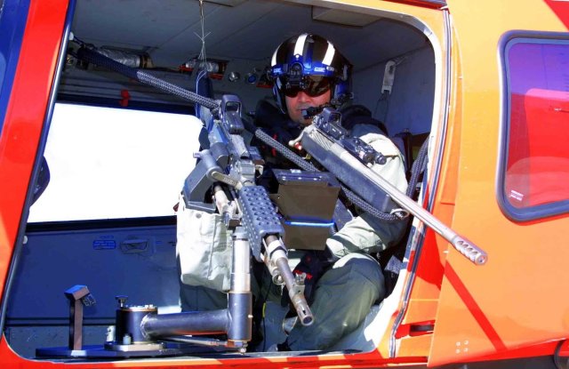 mh_68a_gunner_up_close_with_weapons_ad8803f61d5c2f46e2f6988e1badb351ea409675.jpg